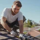 roof repairman working on a house roof free photo 1